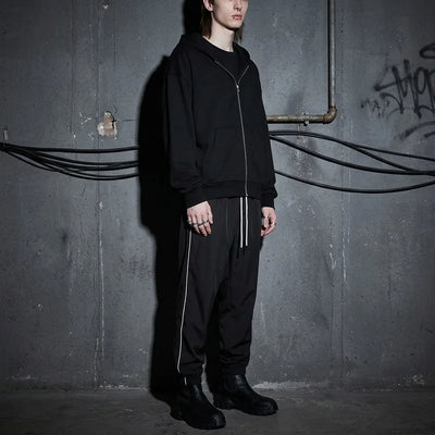Model in Reflective Nightflow Hose, urbaner Look, ideal für Clubnächte.